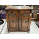 AN EARLY 20TH CENTURY OAK TABLE TOP CABINET MODELLED AS A TWIN DOOR SAFE