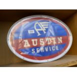 AN ILLUMINATED OVAL 'AUSTIN' SIGN