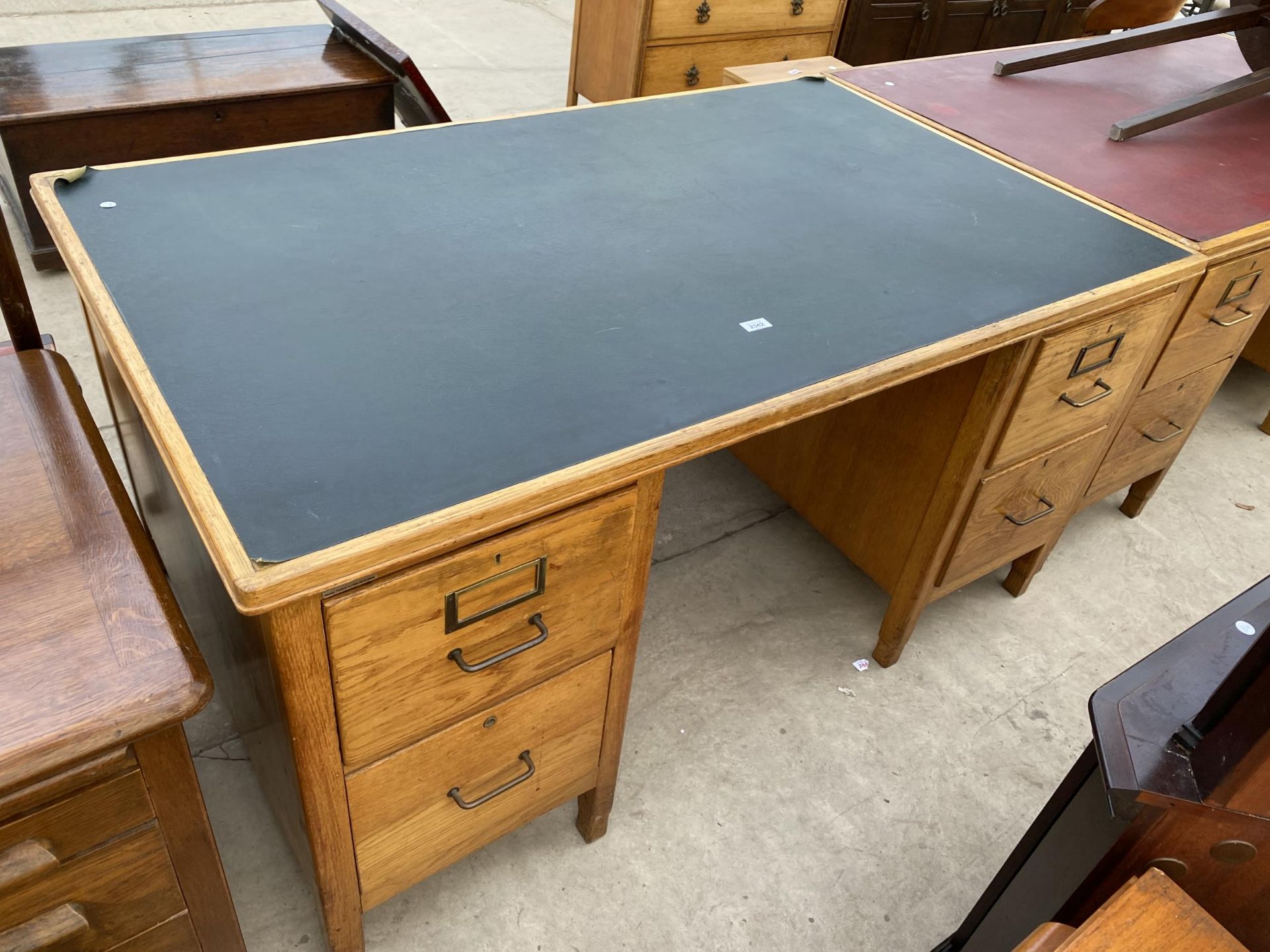 AN OAK TWIN PEDESTAL DESK WITH INSET LEATHERETTE TOP, 60X36"