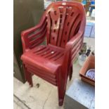 FOUR RED PLASTIC STACKING GARDEN CHAIRS