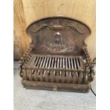 A VINTAGE CAST IRON FIRE GRATE WITH DECORATIVE CAST IRON BACK