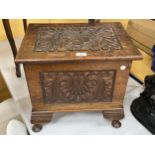 A CARVED OAK DESIGN LIDDED STORAGE BOX