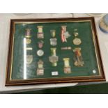 A WOODEN AND GLASS DISPLAY CASE CONTAINING ASSORTED MILITARY MEDALS