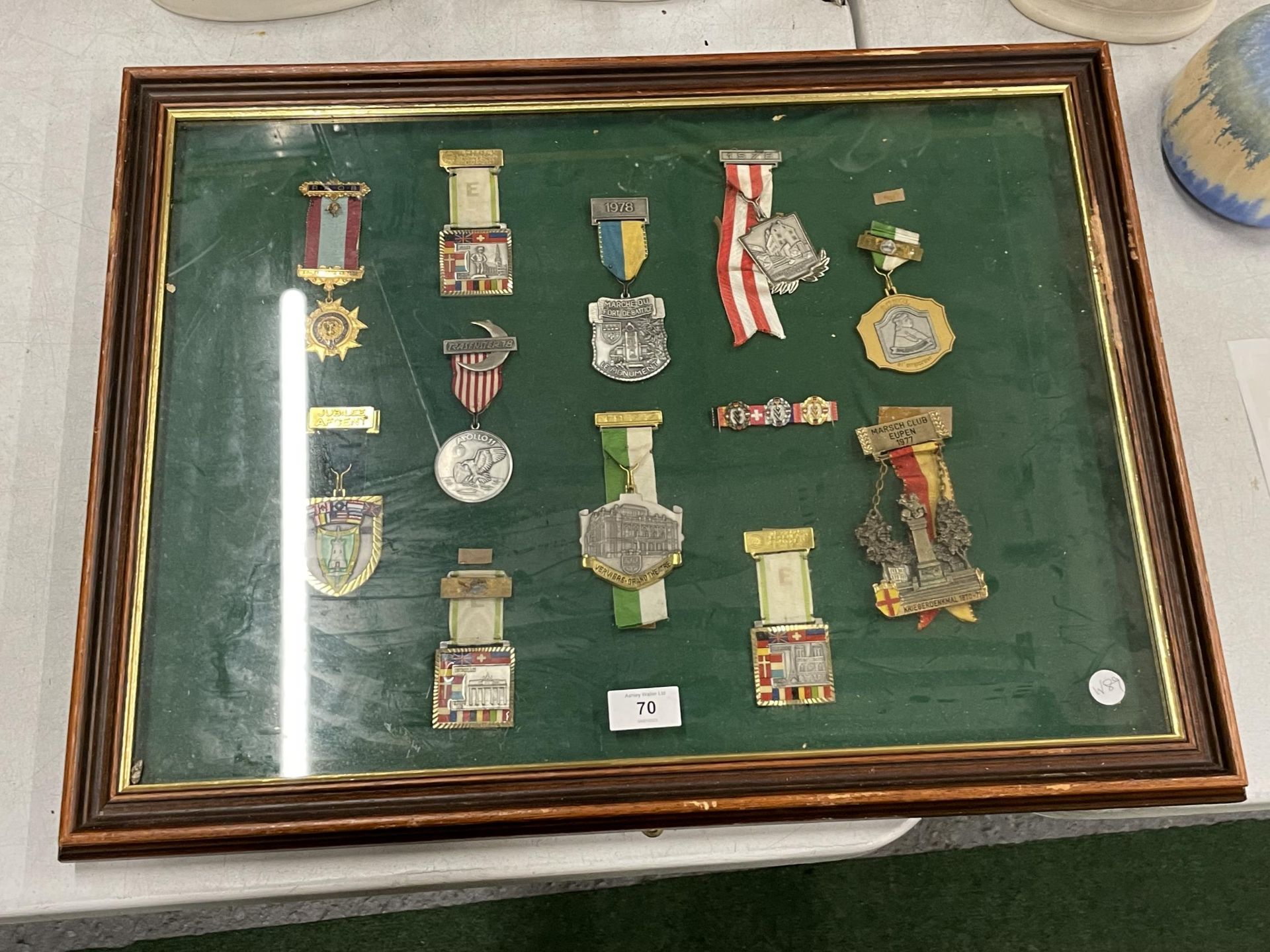A WOODEN AND GLASS DISPLAY CASE CONTAINING ASSORTED MILITARY MEDALS