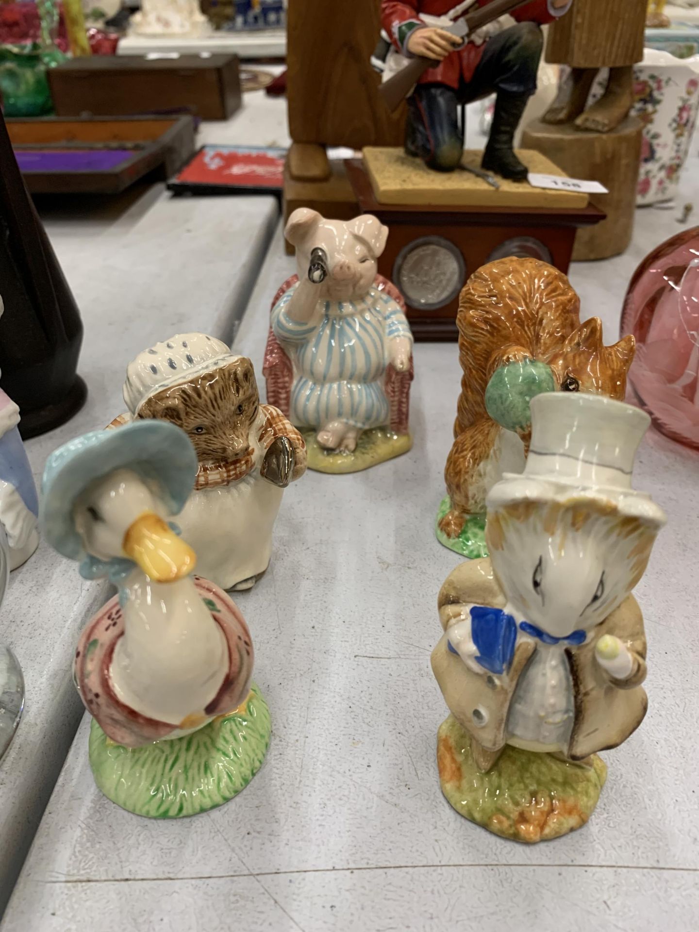 FIVE BESWICK BEATRIX POTTER FIGURES TO INCLUDE AMIABLE GUINEA PIG, JEMIMA PUDDLEDUCK, SQUIRREL
