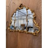 A LARGE DECORATIVE GILT FRAMED WALL MIRROR