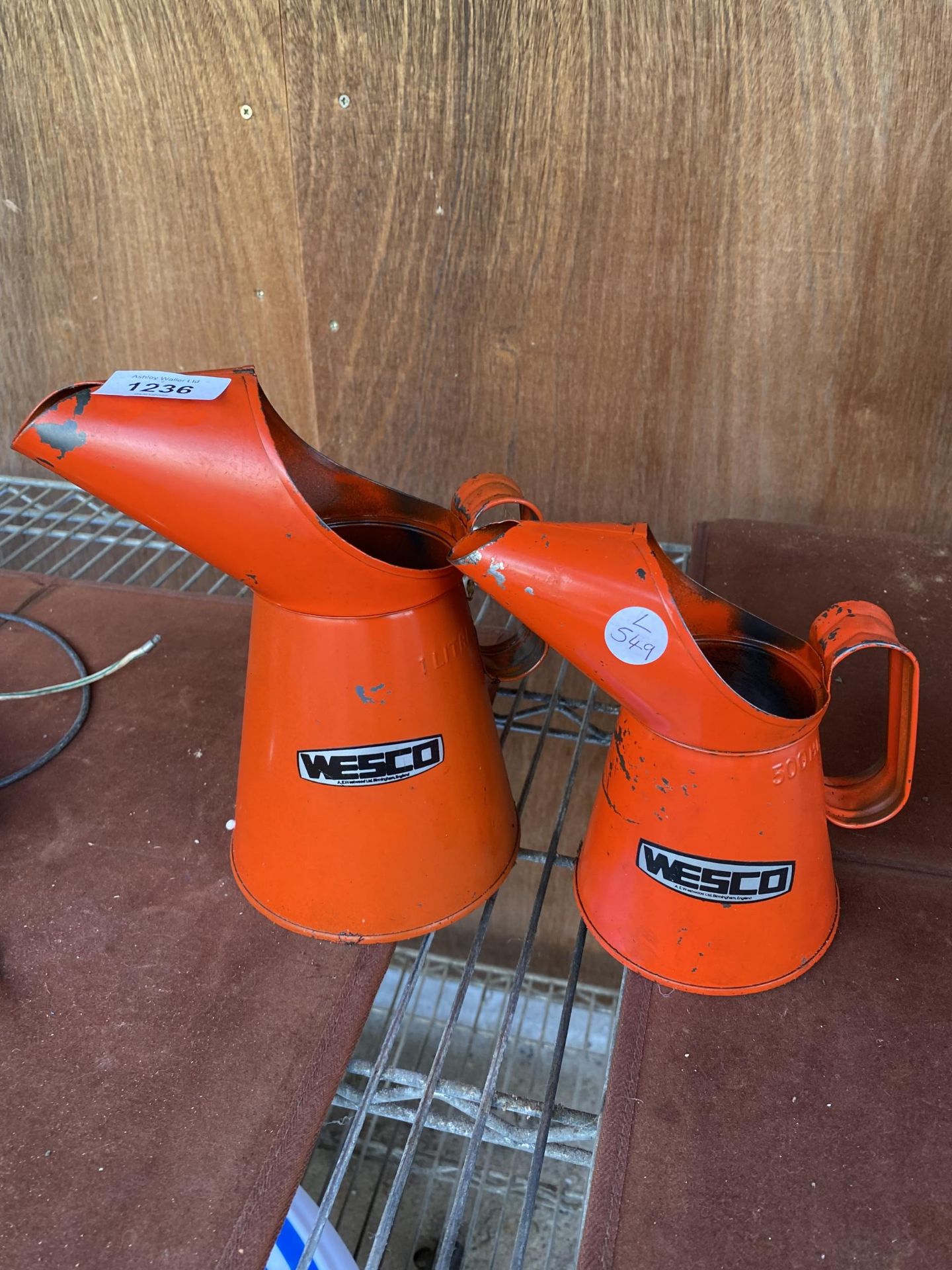 TWO VINTAGE GRADUATED WESCO OIL JUGS