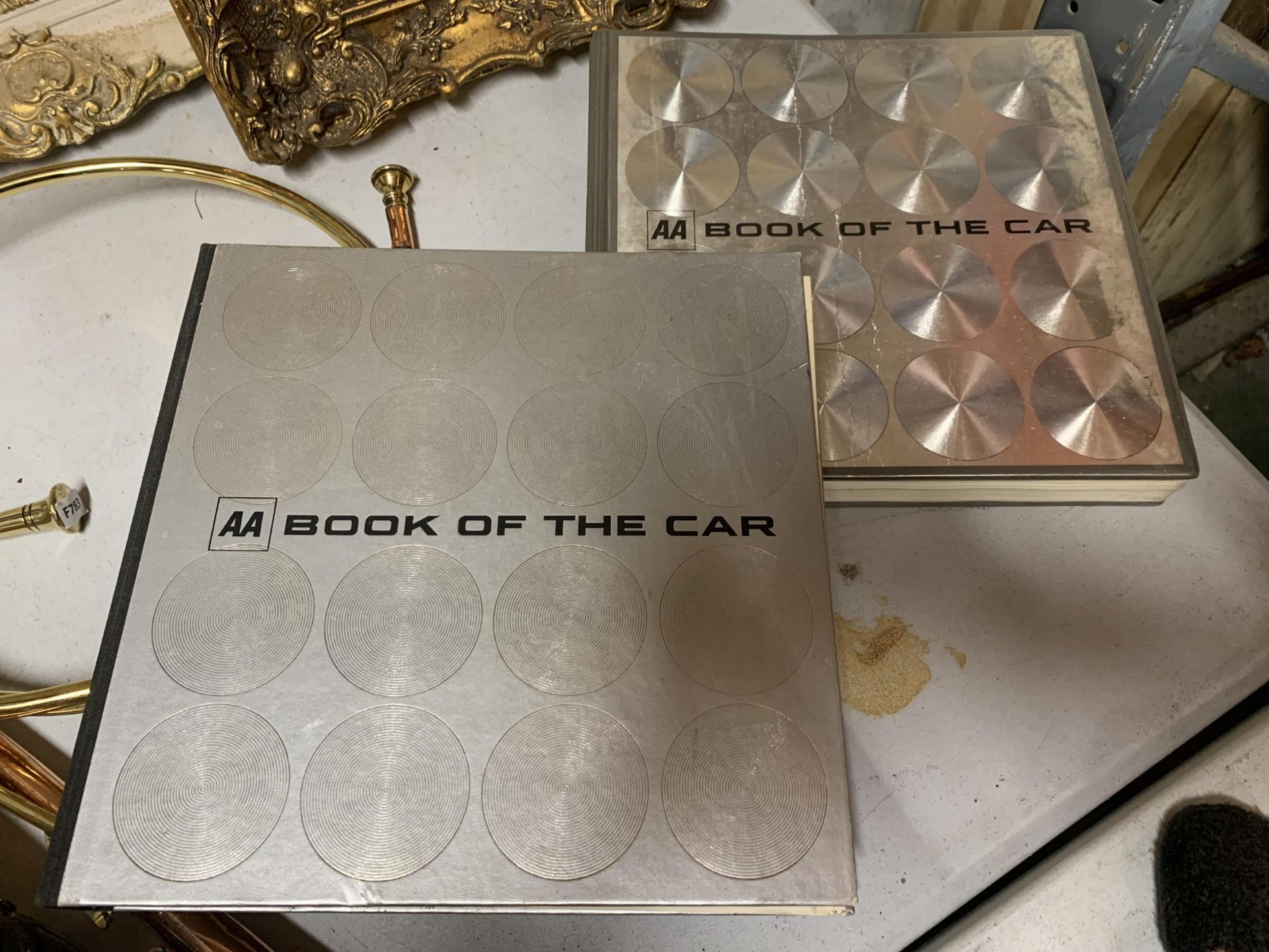 TWO COPIES OF THE AA BOOK OF THE CAR
