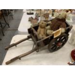 A SMALL WOODEN CART WITH TWO TEDDY BEARS