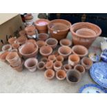 A LARGE ASSORTMENT OF TERRACOTTA PLANT POTS OF VARIOUS SIZES