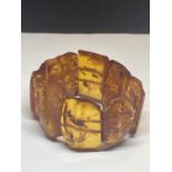 AN AMBER BRACELET CONSISTING OF EIGHT RECTANGULAR STYLE STONES