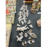 A LARGE QUANTITY OF WHITE CERAMIC MINIATURE FIGURES TO INCLUDE CHERUBS, SHOES, DOVES, ANGELS, ETC