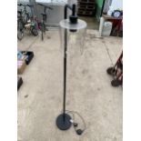 A FLOOR STANDING LAMP WITH GLASS SHADE
