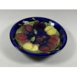 A MOORCROFT 'WISTERIA' BERRY PATTERN DISH