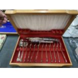 A CANTEEN OF STAINLESS STEEL CUTLERY IN A TEAK BOX
