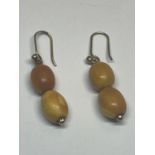 A APIR OF BUTTERSCOTCH AMBER TWO STONE DROP EARRINGS IN A PRESENTATION BOX