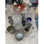 AN ASSORTMENT OF METAL WARE ITEMS TO INCLUDE CANDLESTICKS, TANKARDS AND TWO CLARET JUGS WITH EPNS