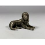 A WHITE METAL MODEL OF A DOG