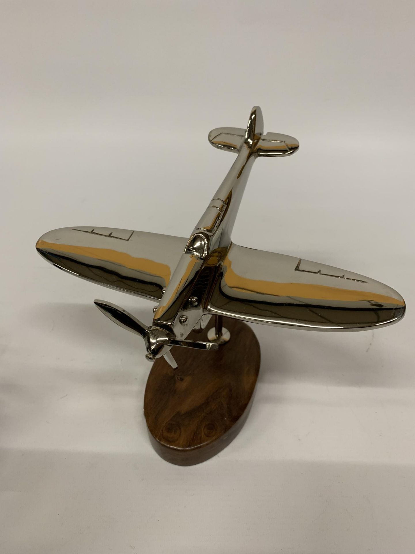 A CHROME SPITFIRE ON A WOODEN BASE HEIGHT 20CM