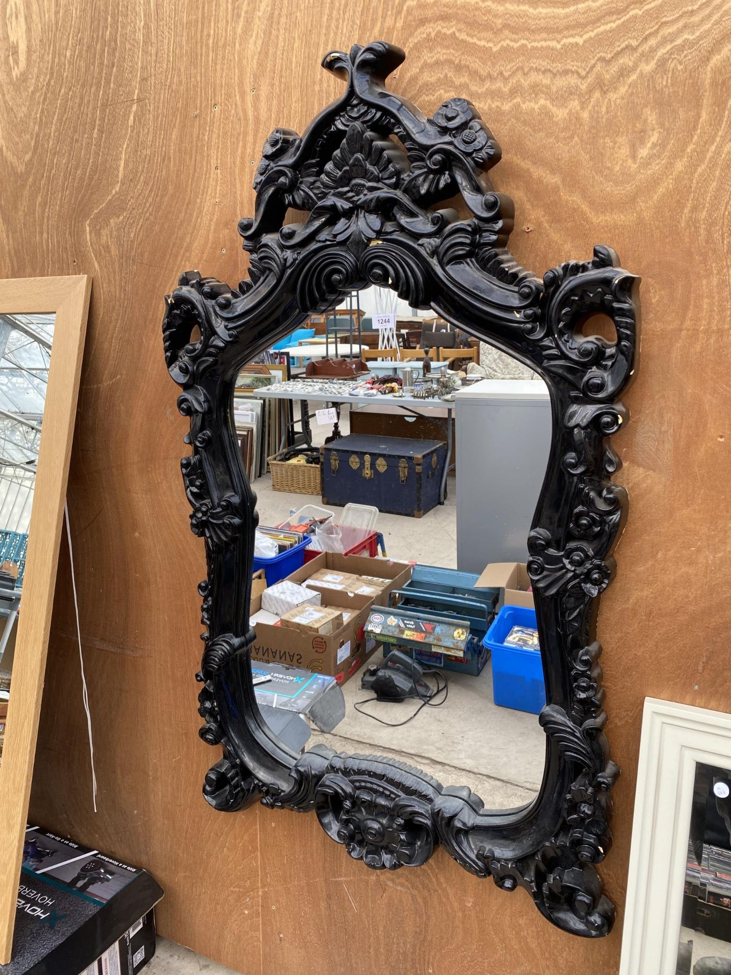 A LARGE ORANATE FRAMED WALL MIRROR