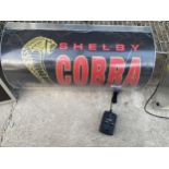 AN ILLUMINATED 'COBRA' SIGN WITH PLUG AND LEAD