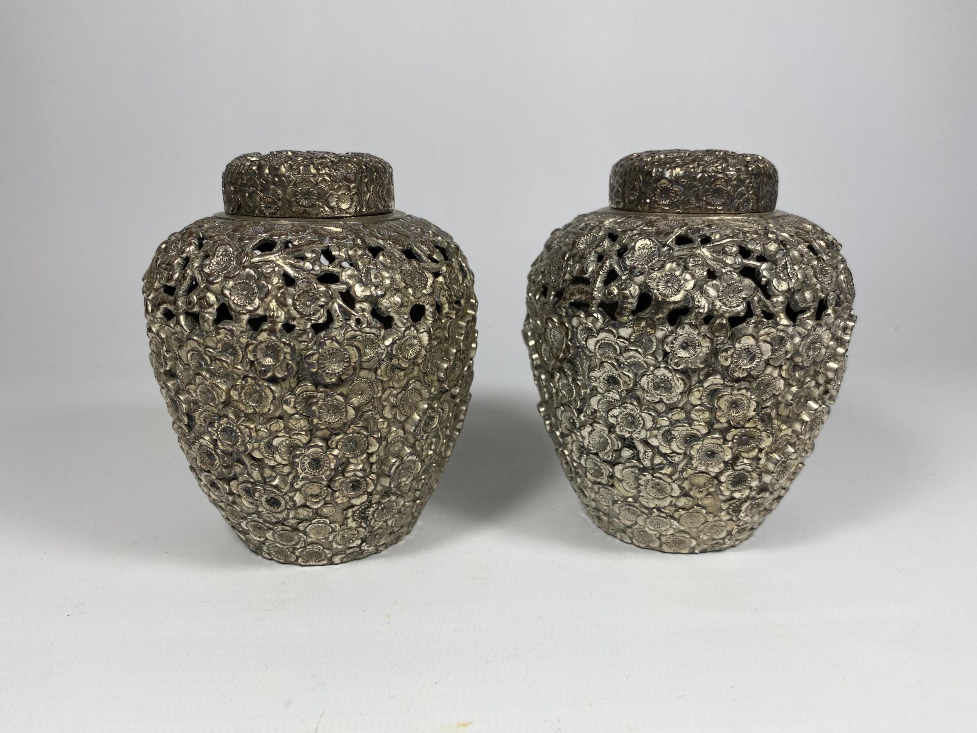 A PAIR OF UNUSUAL WHITE METAL, POSSIBLY CHINESE, LIDDED TEA CADDIES, HEIGHT 11CM