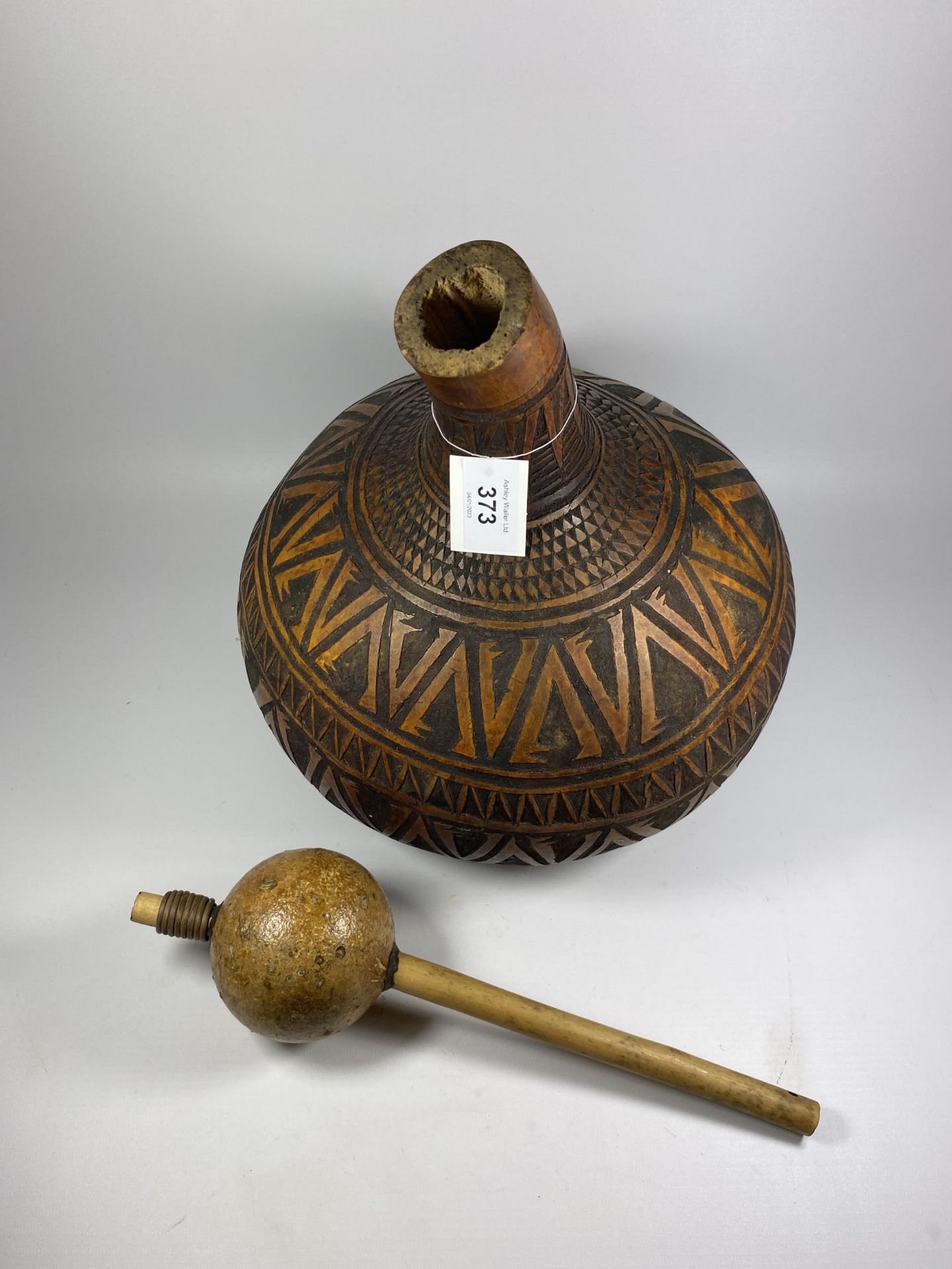 A VINTAGE TRIBAL CARVED WOODEN POPPY SEED GOURD AND SHAKER, HEIGHT - Image 2 of 3