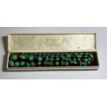 A BOXED ORIENTAL GREEN HARDSTONE NECKLACE