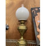 A VINTAGE BRASS OIL LAMP WITH GLASS FUNNEL AND WHITE GLASS SHADE