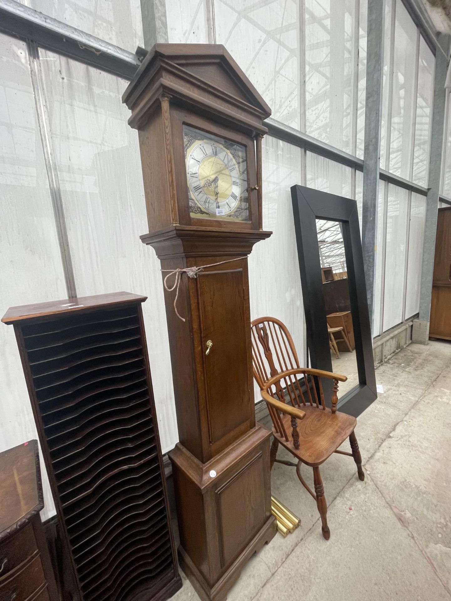 A REPRODUCTION OAK LONGCASE CLOCK WITH BRASS FACE AND THREE BRASS WEIGHTS