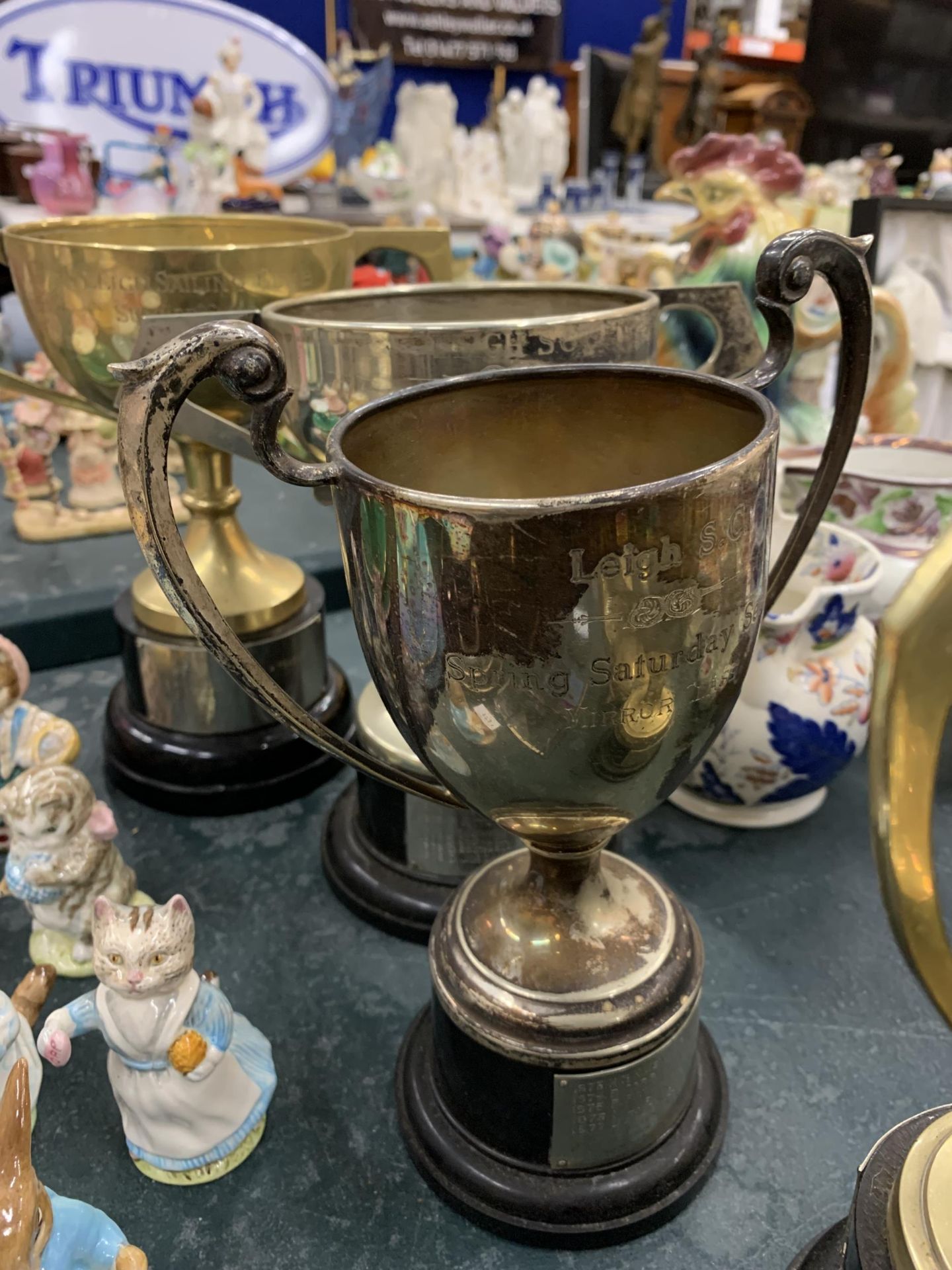 FOUR SILVER PLATED TROPHY CUPS ALL FROM LEIGH SAILING CLUB PLUS A BRASS TEAPOT - Image 3 of 4