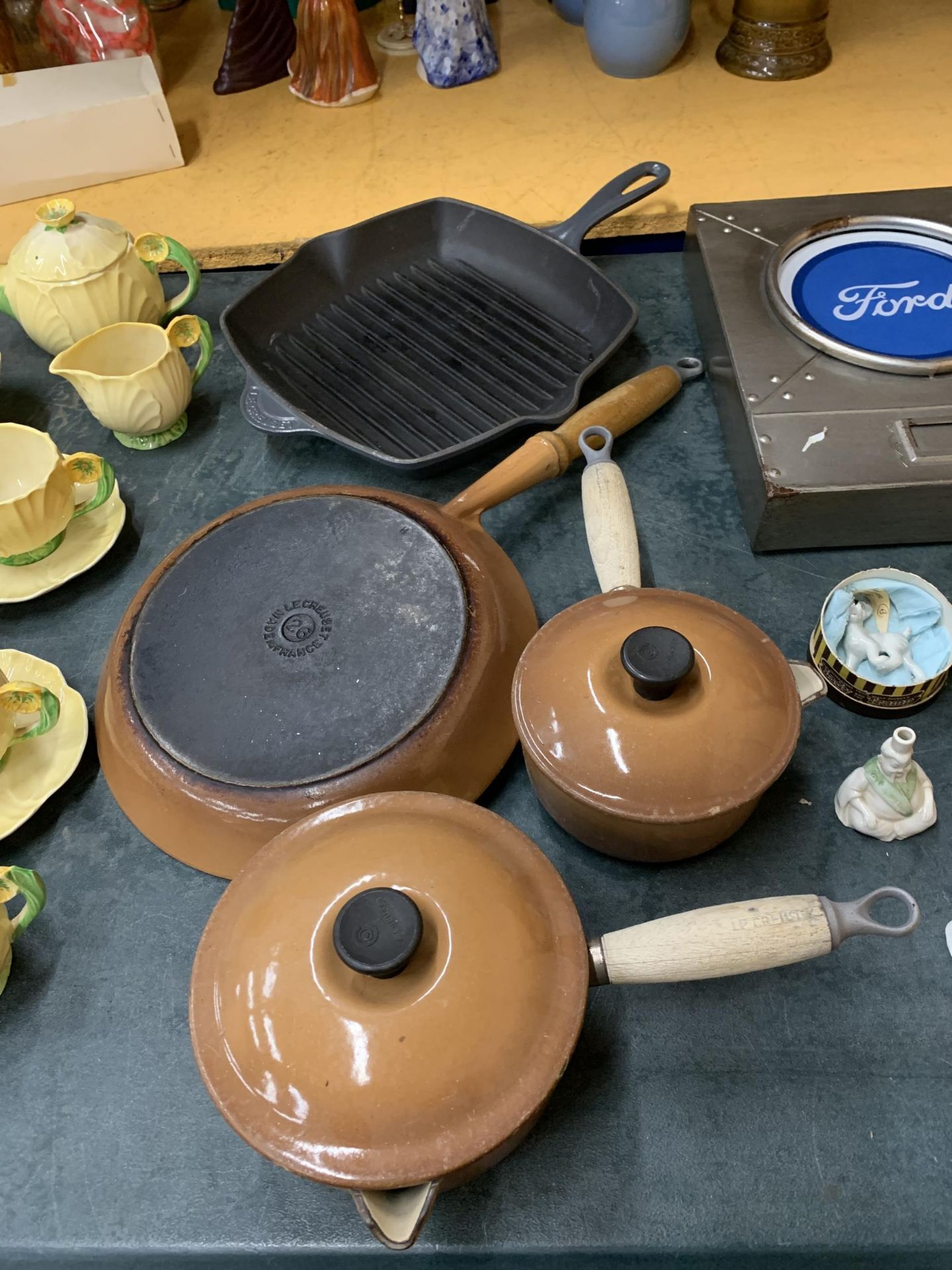 FOUR LE CREUSET PANS TO INCLUDE A GRIDDLE, FRYING PAN AND TWO SAUCEPANS