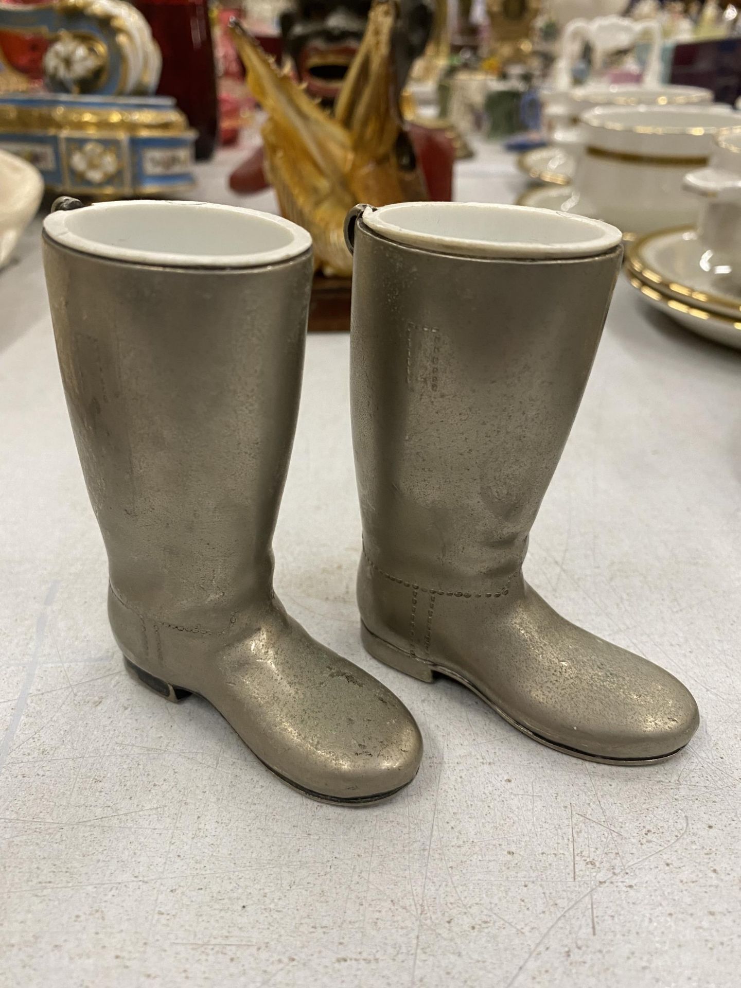 A PAIR OF SILVER PLATED WELLY BOOTS, ONE WEIGHING 1 oz, THE OTHER 1.5 oz, HEIGHT 9CM