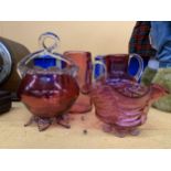 FOUR VINTAGE CRANBERRY GLASS ITEMS TO INCLUDE JUGS AND BOWLS WITH PONTIL MARKS