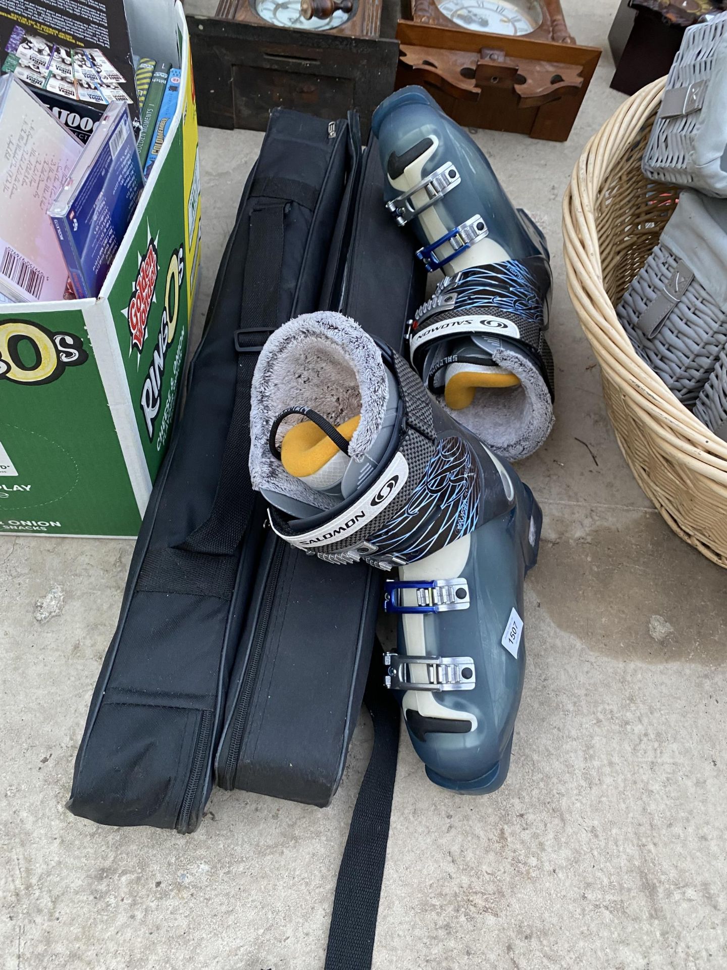 A PAIR OF SKI BOOTS AND TO FOLDING DISPLAY STANDS