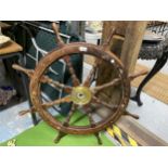 A VINTAGE WOODEN SHIP'S STEERING WHEEL