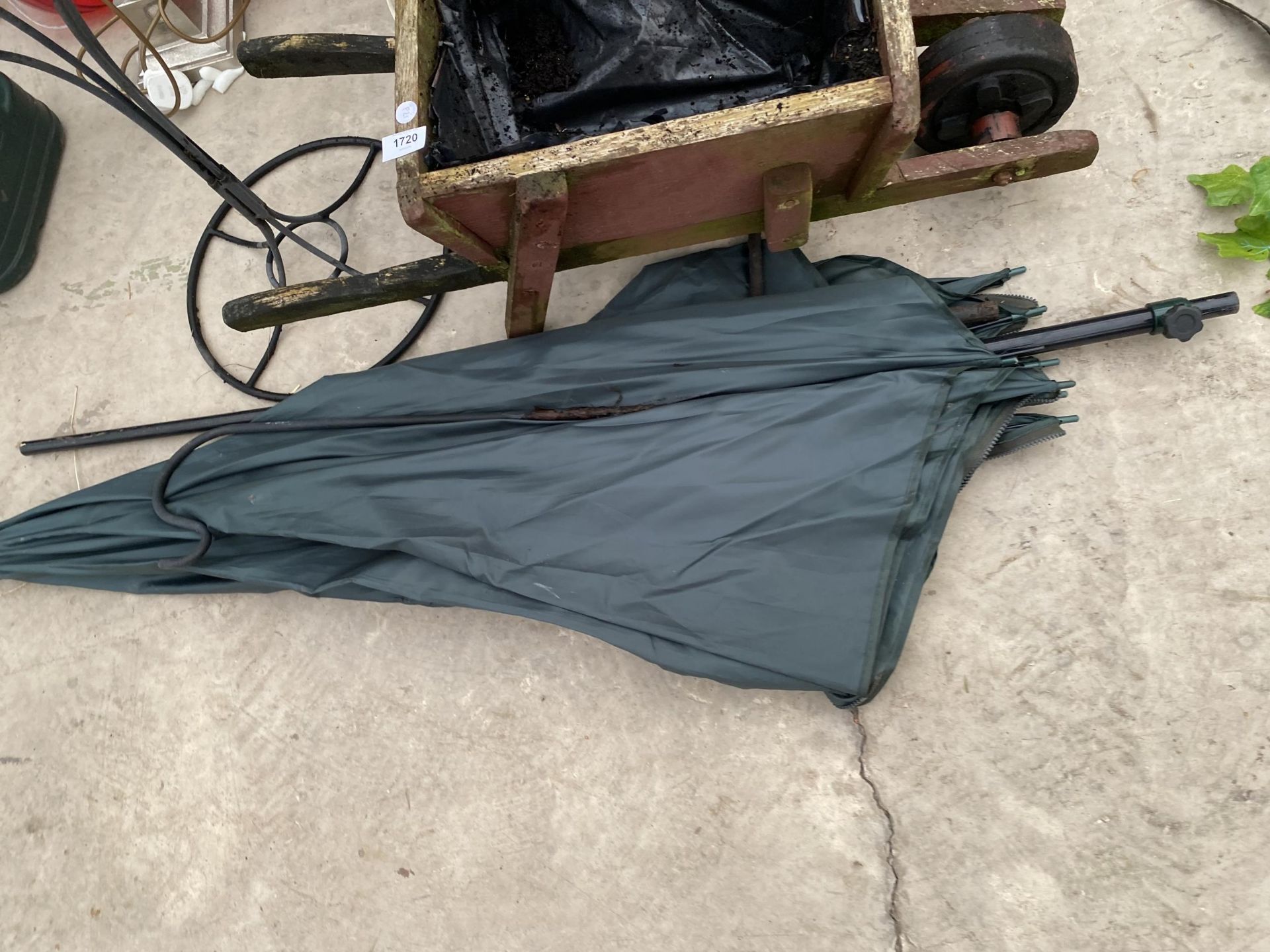 A WOODEN WHEEL BARROW PLANTER, A WROUGHT IRON PLANTER AND A FISHING BROLLY - Image 3 of 5