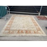 A LARGE CREAM AND ORANGE RUG