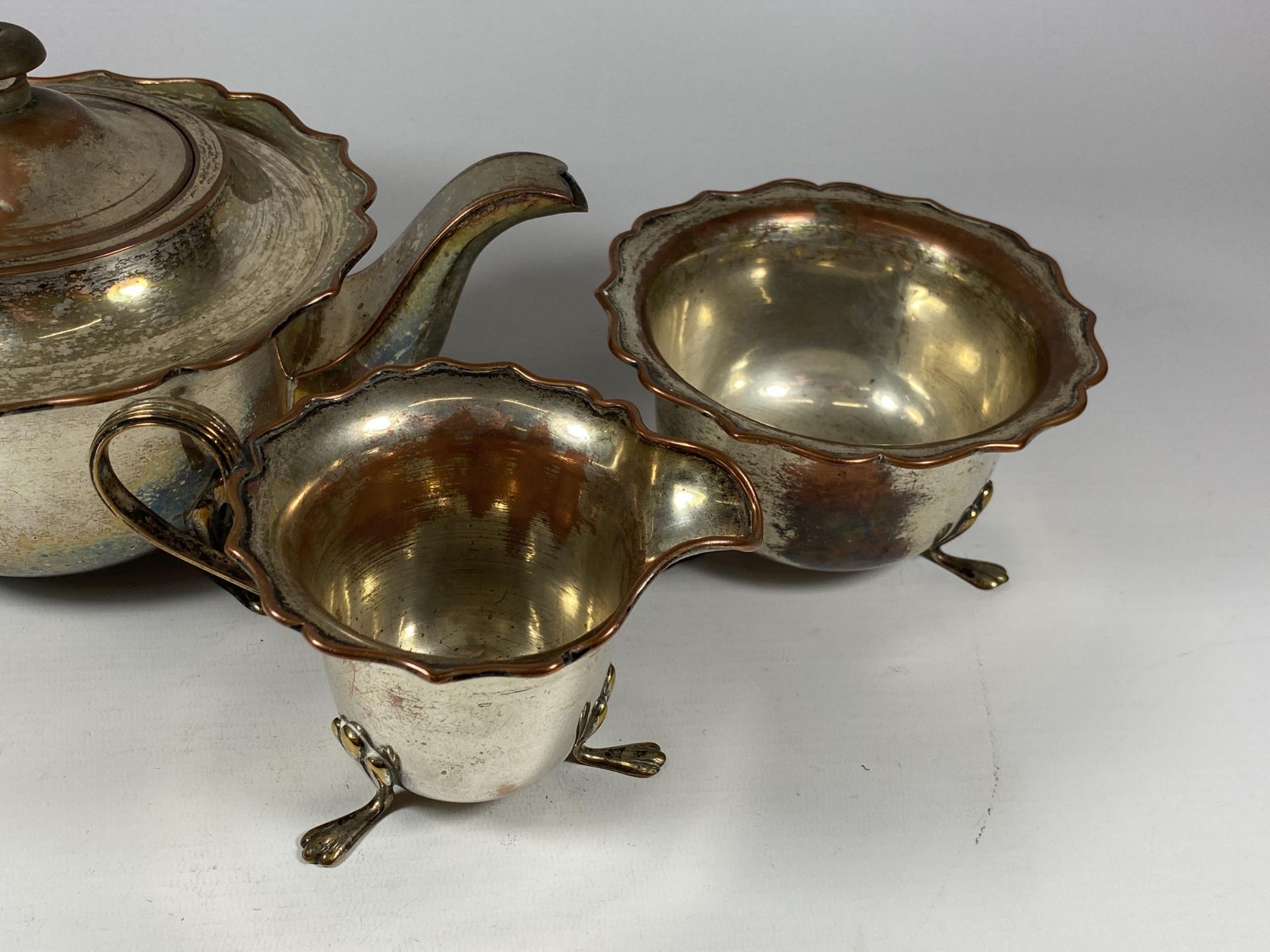 A VINTAGE SILVER PLATE ON COPPER THREE PIECE TEA SET - Image 3 of 3