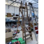 A VINTAGE 7 RUNG WOODEN STEP LADDER AND A FURTHER 4 RUNG WOODEN STEP LADDER
