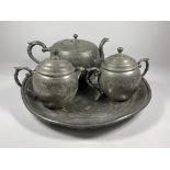 A CHINESE HUIKEE SWATOW PEWTER FOUR PIECE TEA SET COMPRISING TEAPOT, DRINKS TRAY, LIDDED SUGAR