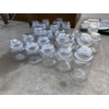 A LARGE ASSORTMENT OF GLASS STORAGE JARS WITH LIDS