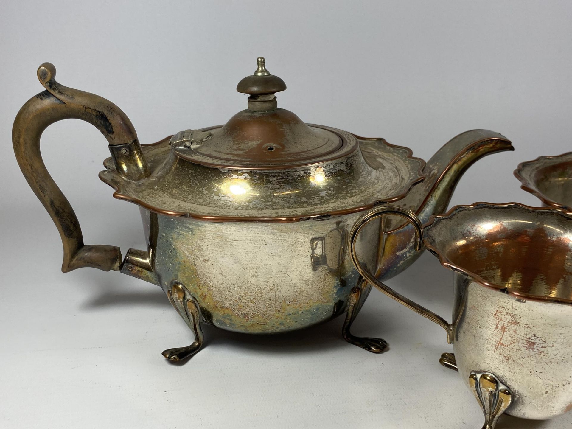 A VINTAGE SILVER PLATE ON COPPER THREE PIECE TEA SET - Image 2 of 3