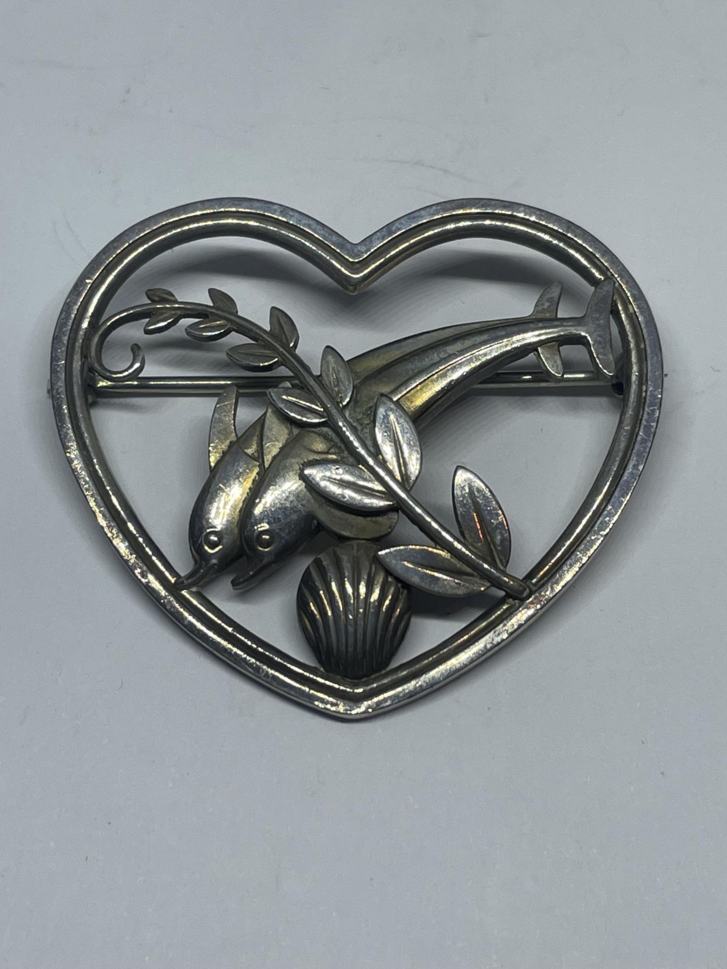 A GEORG JENSON SILVER BROOCH IN A HEART AND DOLPHIN 312 IN A PRESENTATION BOX