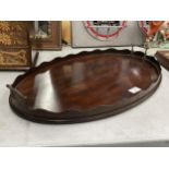AN EARLY 20TH CENTURY MAHOGANY BUTLER'S TRAY WITH GALLERY SIDES AND BRASS HANDLES
