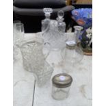 AN ASSORTMENT OF GLASS WARE TO INCLUDE DECANTERS, JUGS AND A BASKET ETC