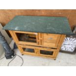 A WOODEN TWO TIER RABBIT HUTCH