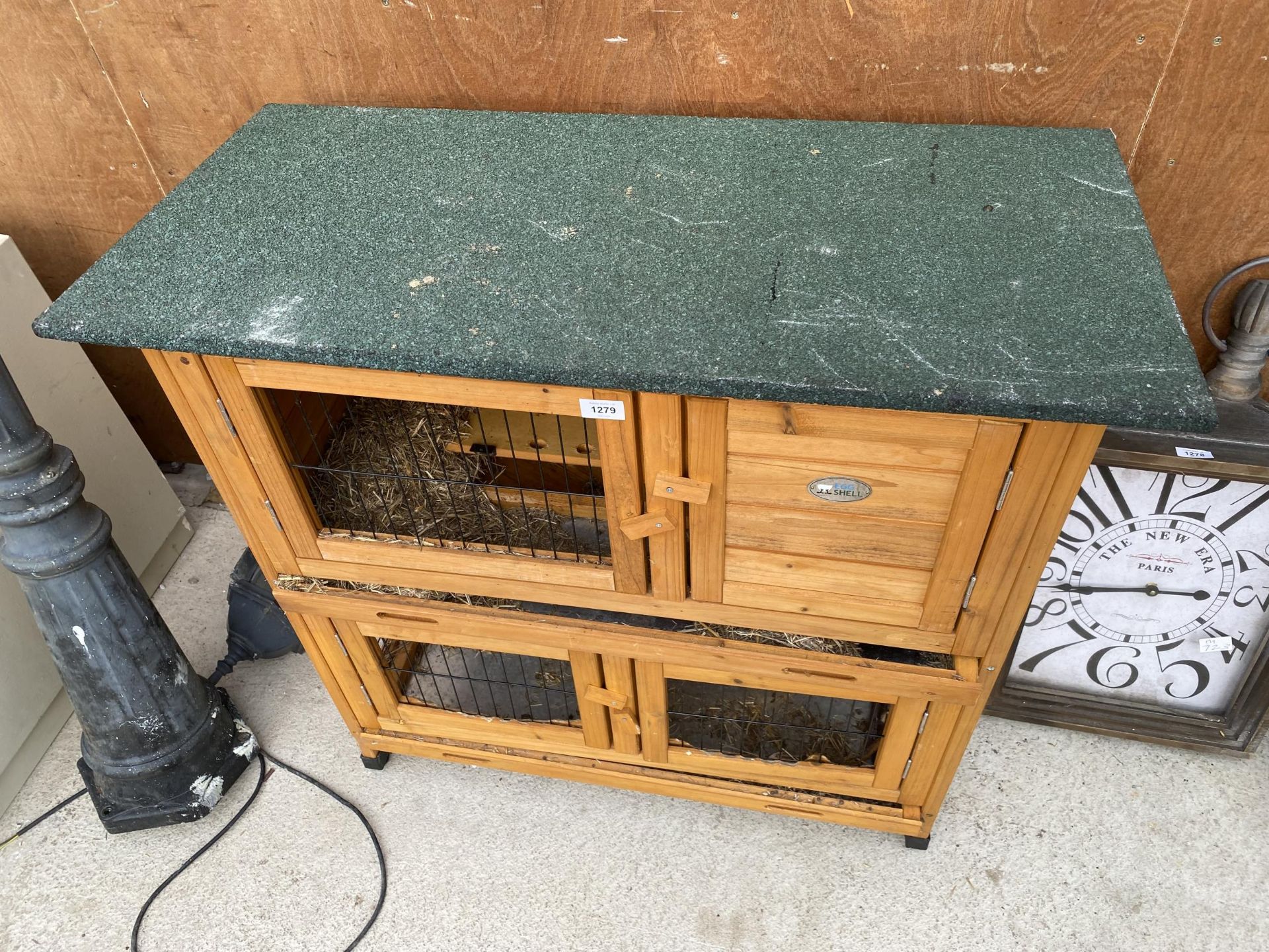 A WOODEN TWO TIER RABBIT HUTCH