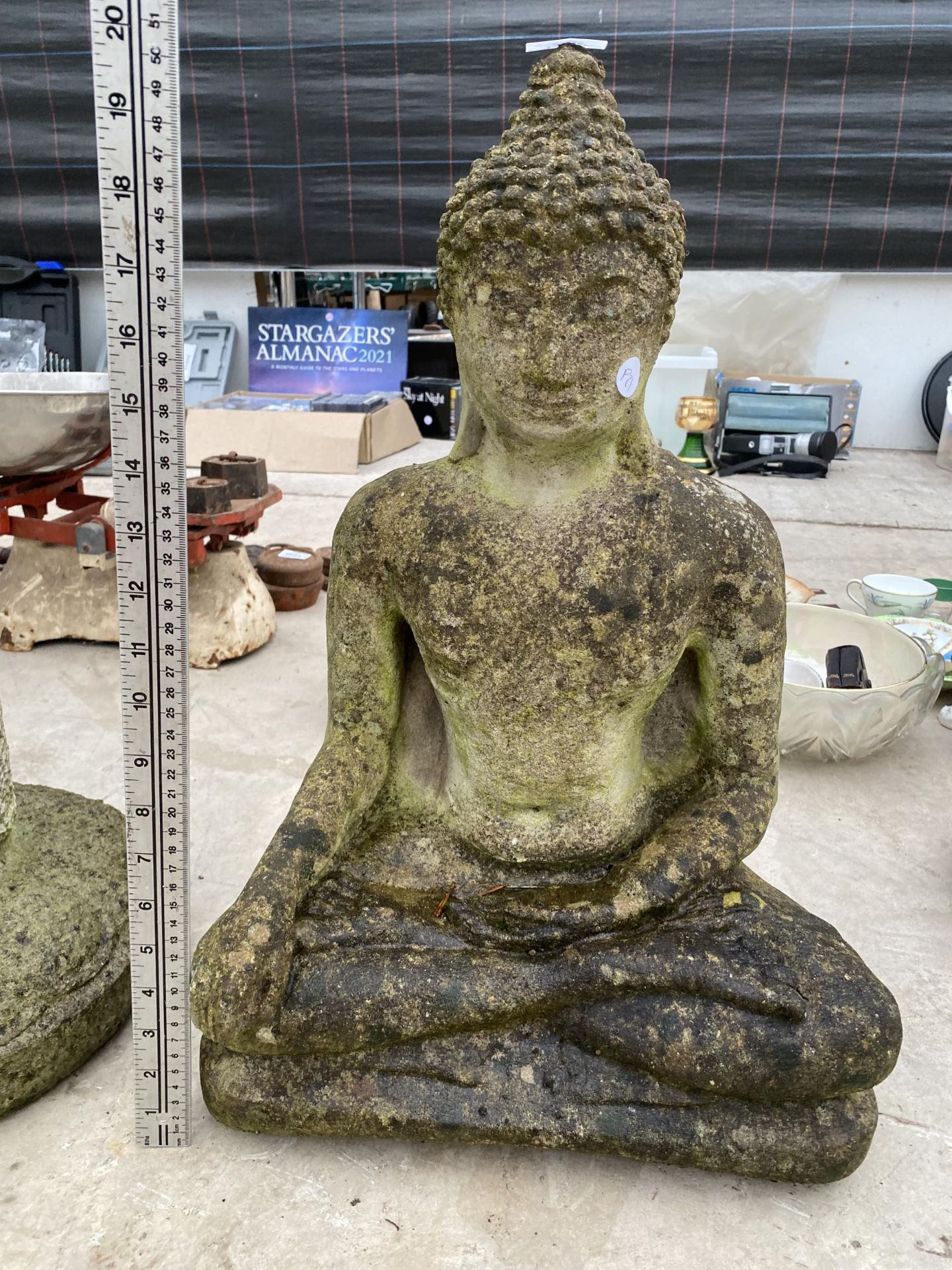 A RECONSITUTED STONE GARDEN FIGURE OF A BUDDAH