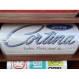 AN ILLUMINATED 'CORTINA' SIGN WITH PLUG AND LEAD